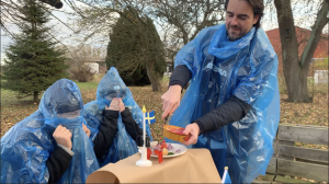 Matthias opening a can of smelly fish from Sweden, called surströmming
